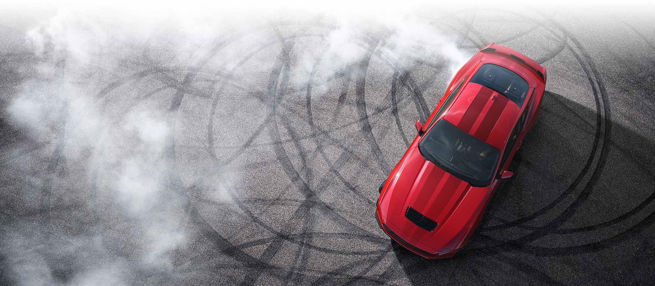 Overhead view of a 2024 Ford Mustang® model with tire tracks on pavement | Lynch Ford of Mukwonago in Mukwonago WI