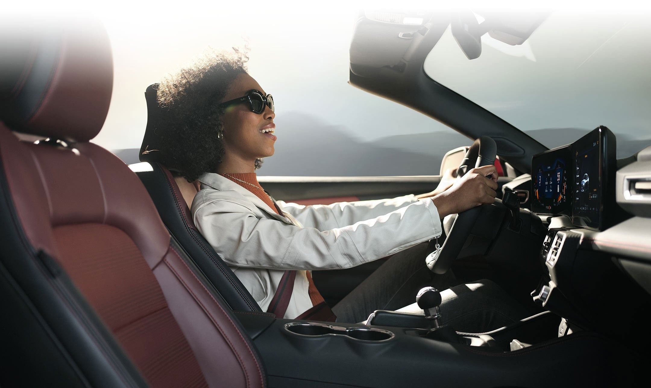 Person sitting in the driver’s seat of a 2024 Ford Mustang® convertible | Lynch Ford of Mukwonago in Mukwonago WI