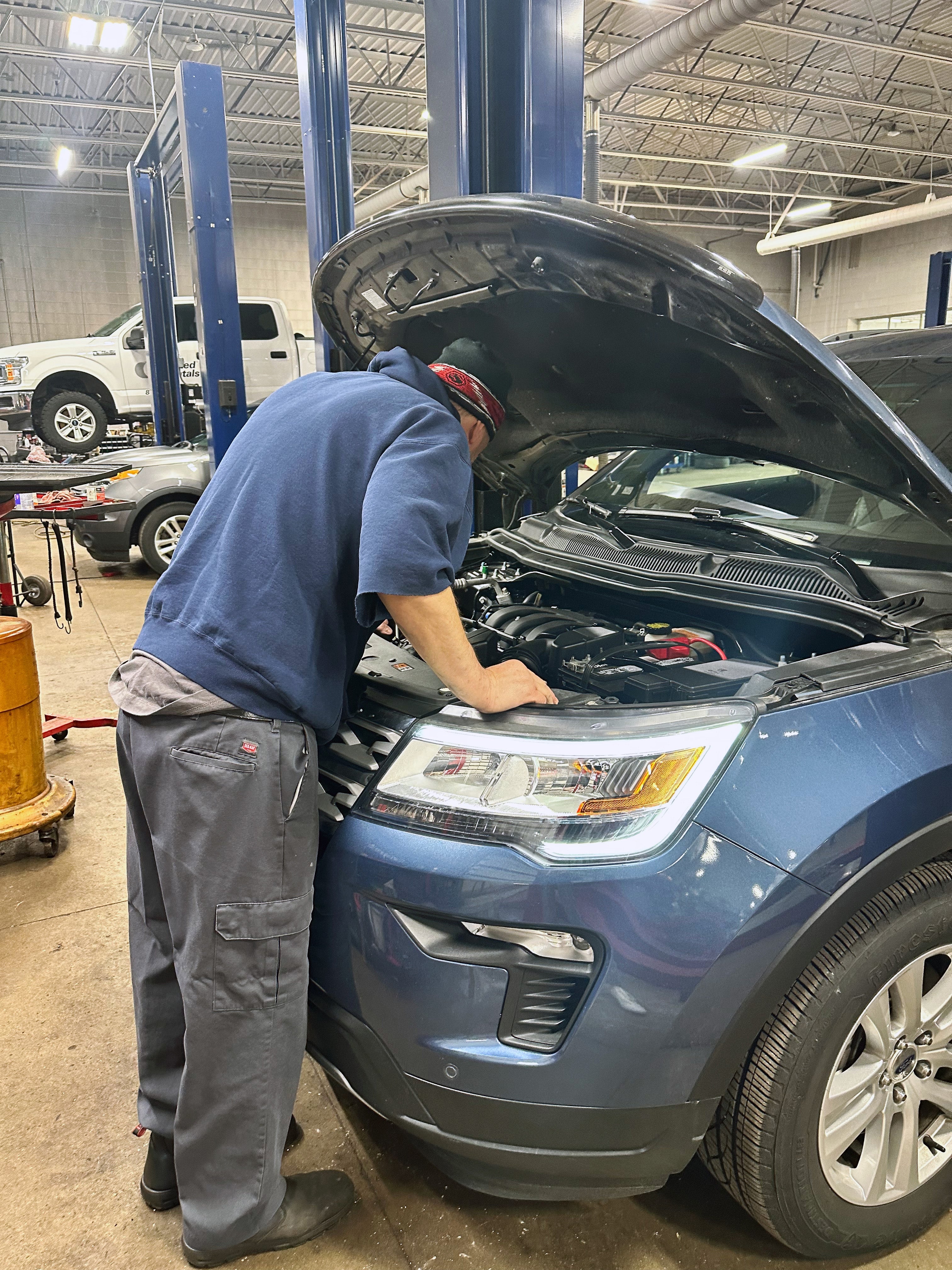 Technician Looking At Engine